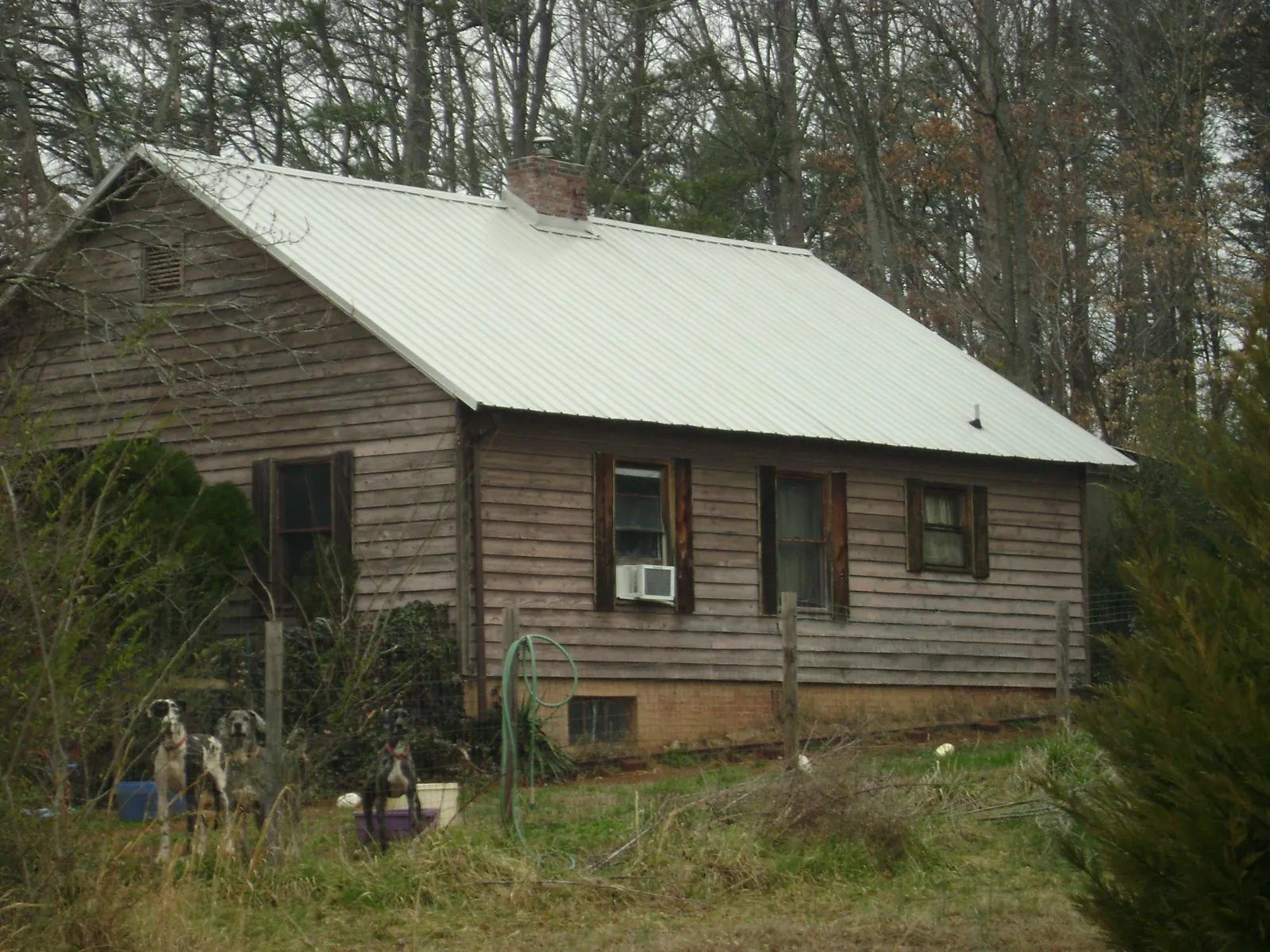 White metal roof on an old wood sided farmhouse in Sherman